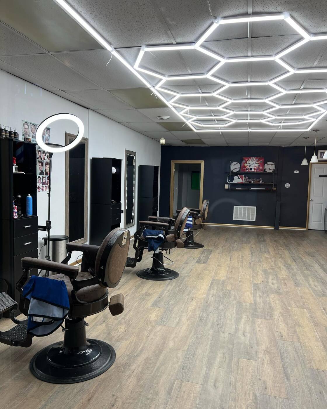 Interior of God With Us Barber Shop with chairs, mirrors, and workstation lighting